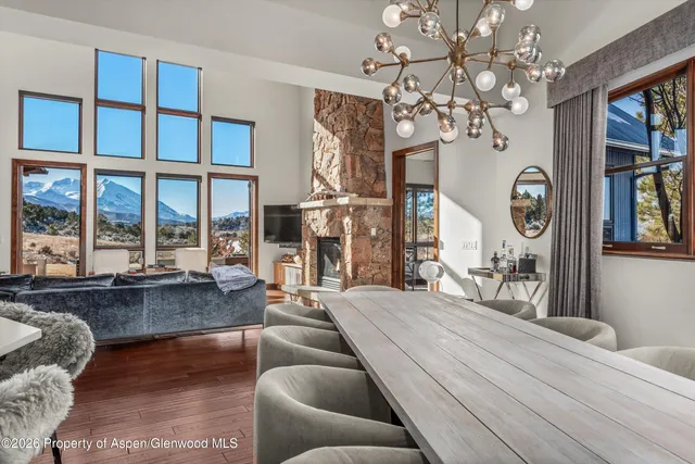 a living room with furniture a chandelier and a large window