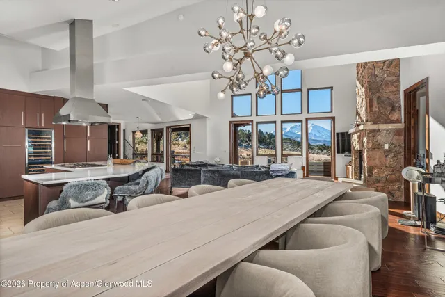 a living room with furniture a chandelier and a flat screen tv
