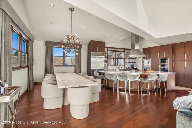 a dining table with chairs and window