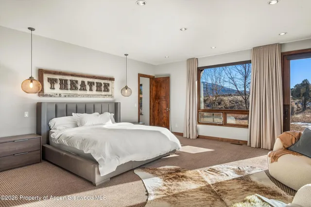 a bedroom with a large bed and a window