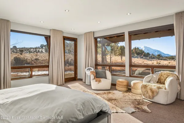 a bedroom with a bed and glass window