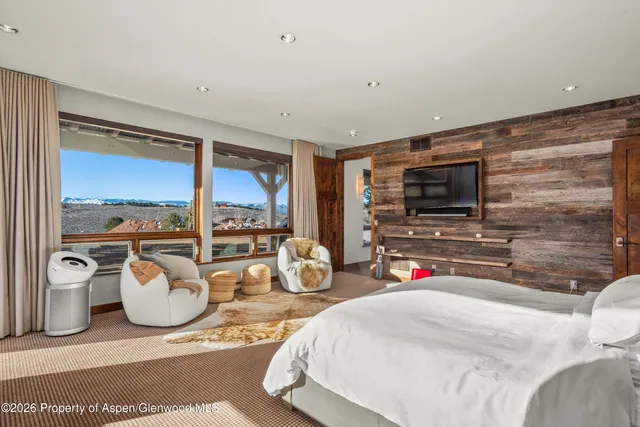a bedroom with furniture and flat screen tv