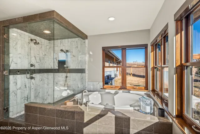 a living room with a couch and a chandelier