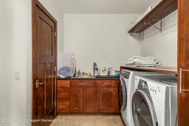 a view of a storage and utility room with washer and dryer