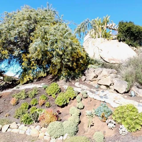 a view of backyard with outdoor seating and green space