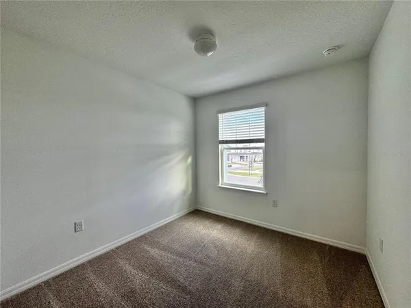 an empty room with closet area and bathroom
