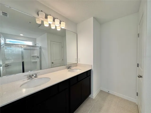 a bathroom with a shower a toilet and a glass window
