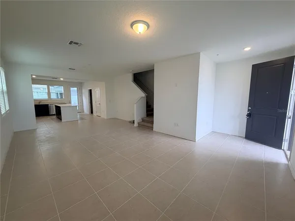 an empty room with windows and entrance