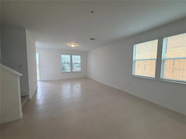 an empty room with windows and entrance