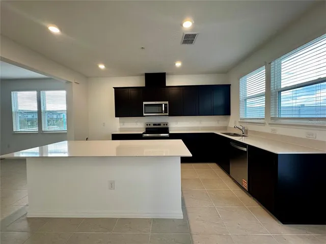 a kitchen with a sink and a stove