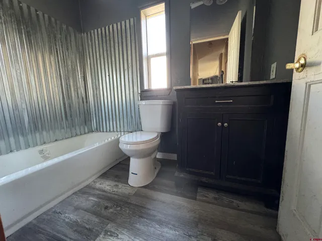 a bathroom with a toilet a sink and bathtub