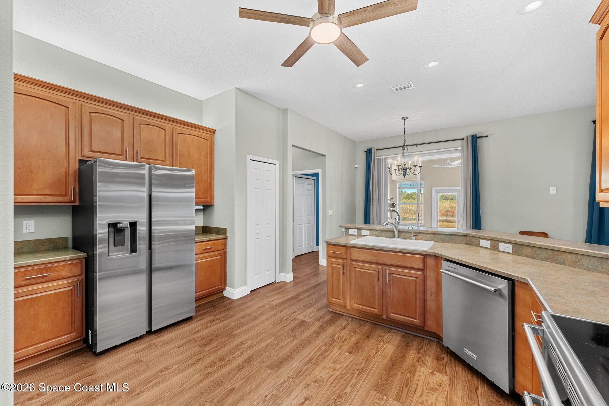 1305 Pemberton Trail Malabar, FL 32950 - Photo 15 of 69 a kitchen with stainless steel appliances granite countertop a refrigerator a sink dishwasher a stove and white countertops with wooden floor