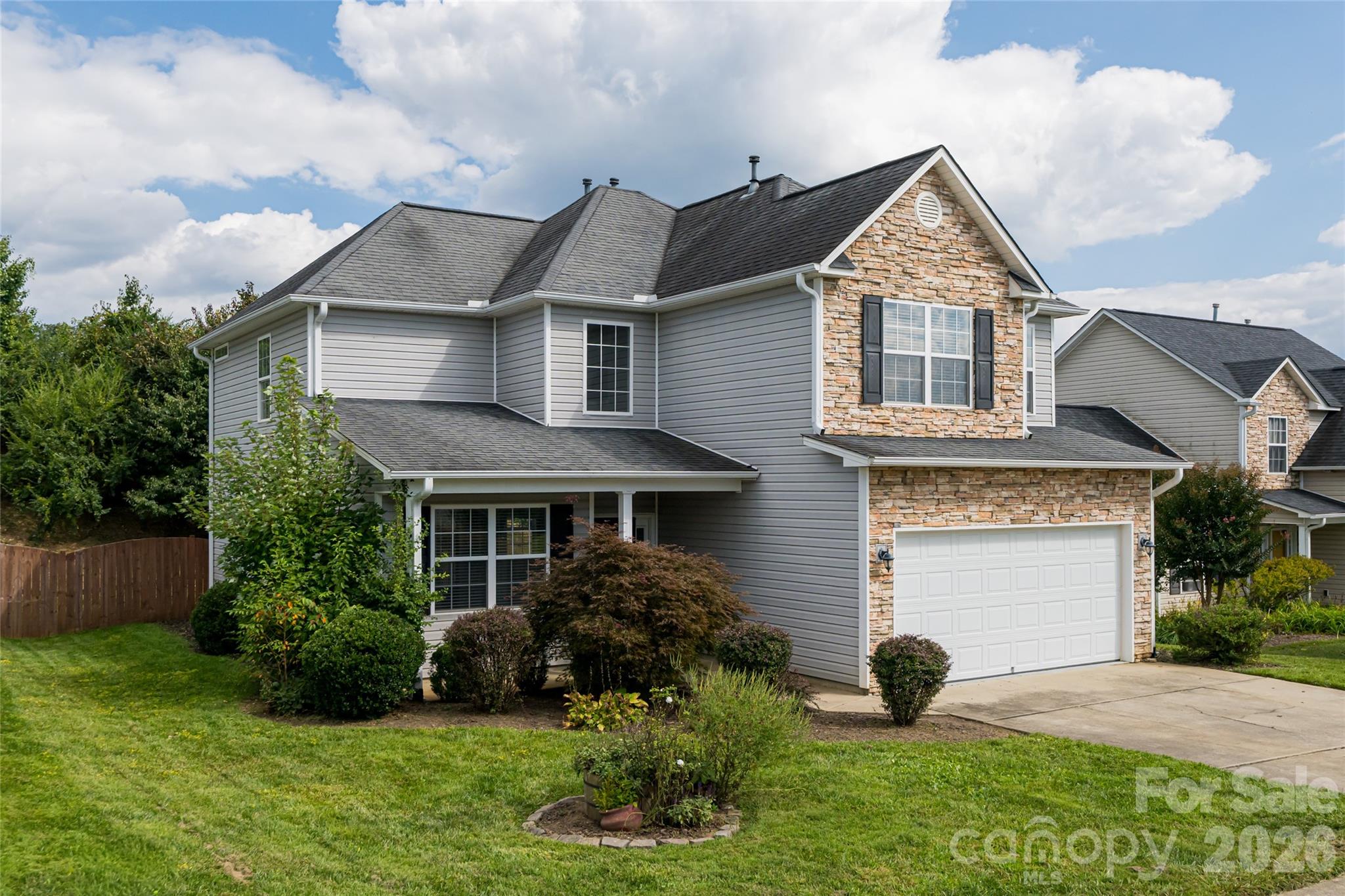 163 Yadkin Road Fletcher, NC 28732 - Photo 1 of 43 a front view of a house with a garden
