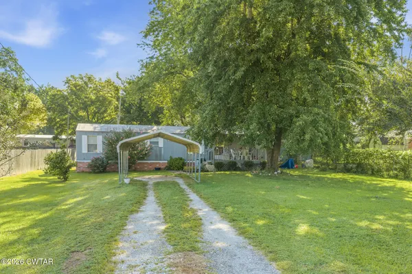 a view of a yard with a house in the background