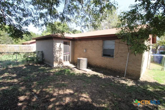 a backyard of a house with plants and trees