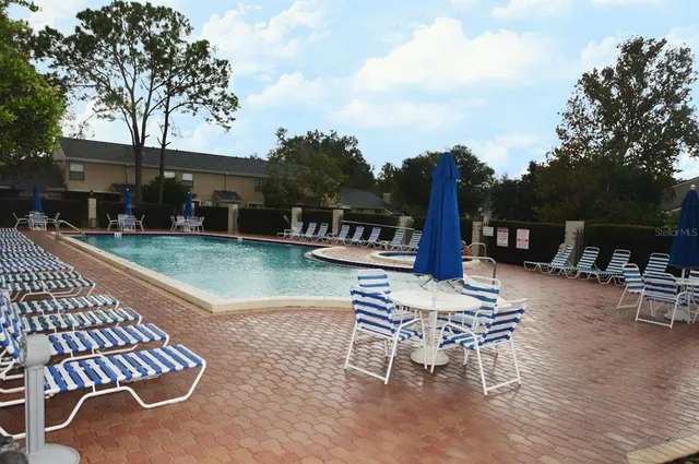 a view of a patio with a table and chairs