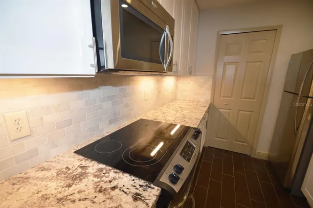 a stove top oven sitting inside of a kitchen