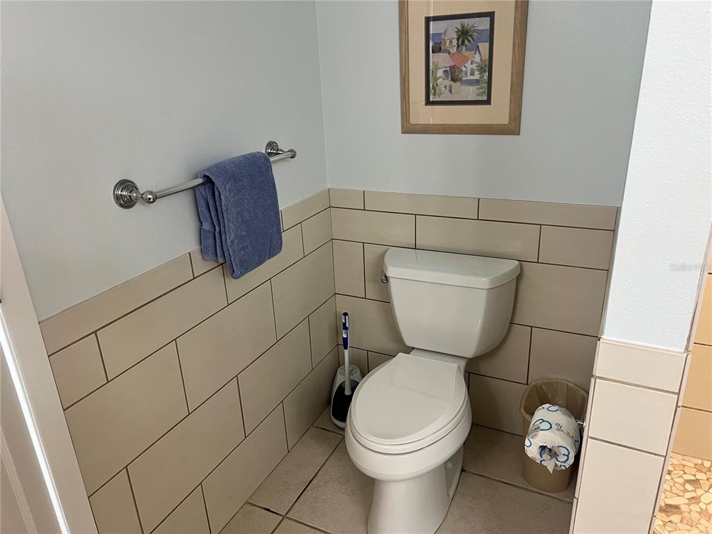 1001 Point Of Rocks Road, Unit 212 Sarasota, FL 34242 - Photo 13 of 36 a bathroom with a toilet and a shower