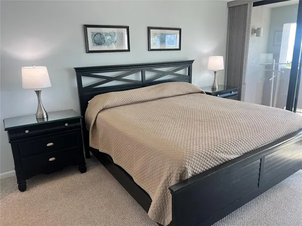 a bedroom with a bed and a lamp