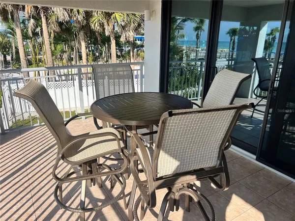 a view of a patio with table and chairs and potted plants