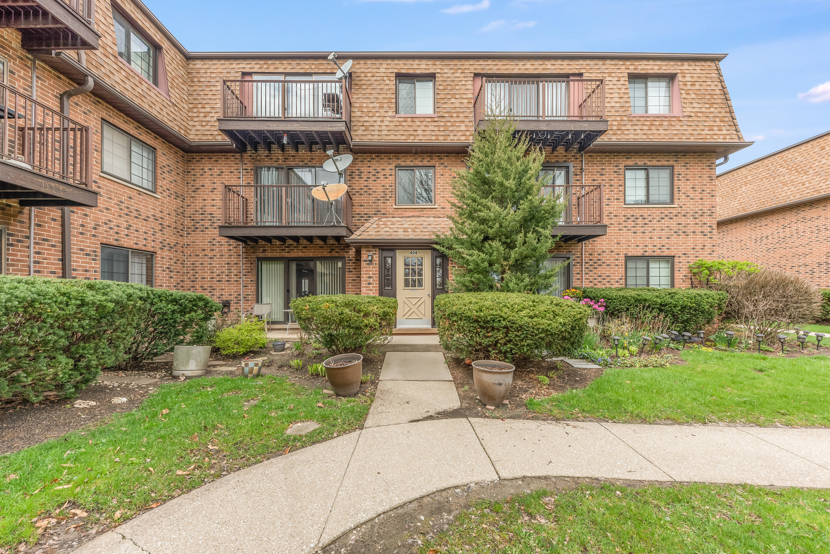a front view of a brick house with a yard