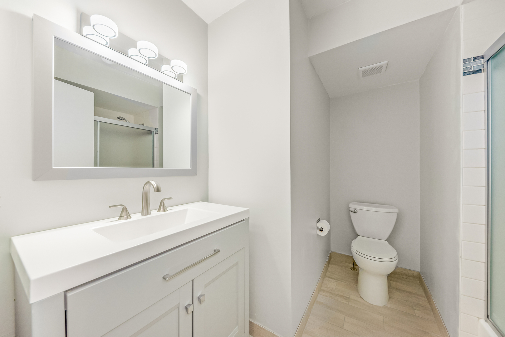 404 East Kensington Road, Unit C Mount Prospect, IL 60056 - Photo 12 of 16 a bathroom with a toilet sink and mirror