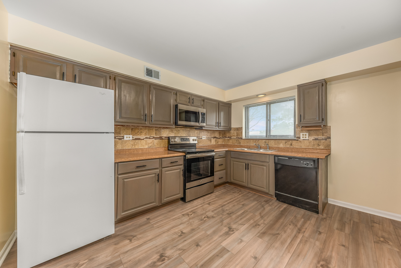 404 East Kensington Road, Unit C Mount Prospect, IL 60056 - Photo 3 of 16 a kitchen with a refrigerator stove top oven and sink