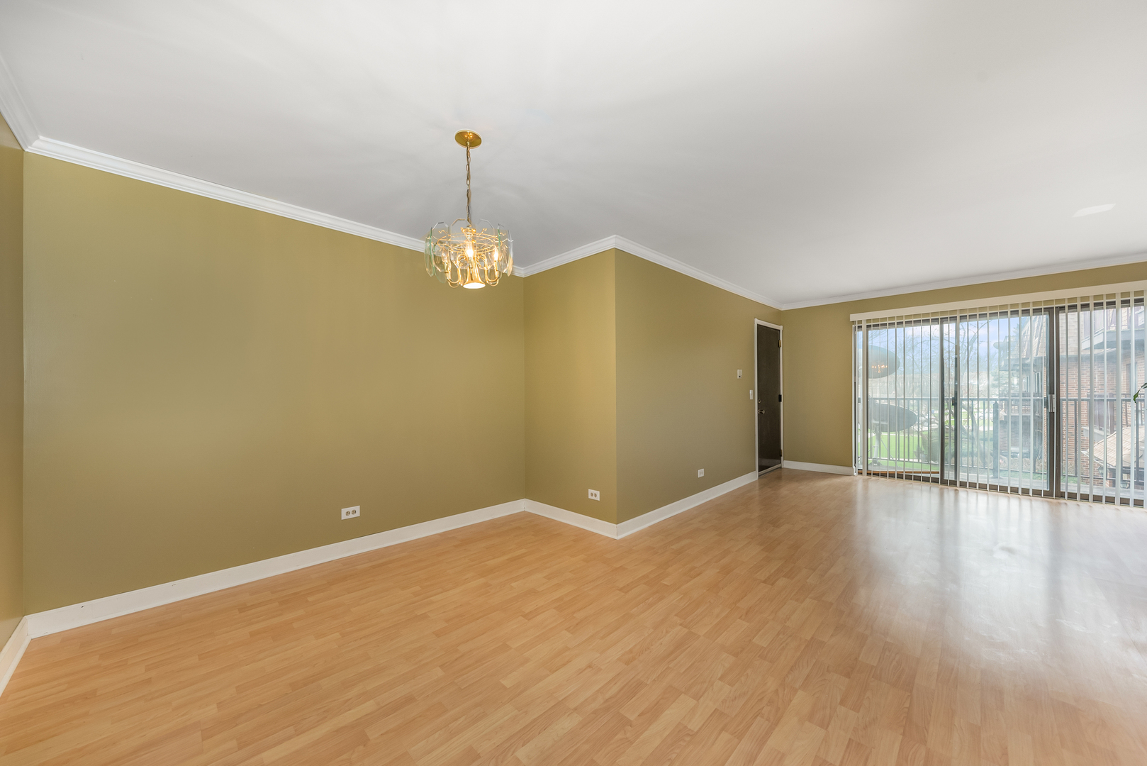 404 East Kensington Road, Unit C Mount Prospect, IL 60056 - Photo 6 of 16 a view of an empty room with wooden floor and a window