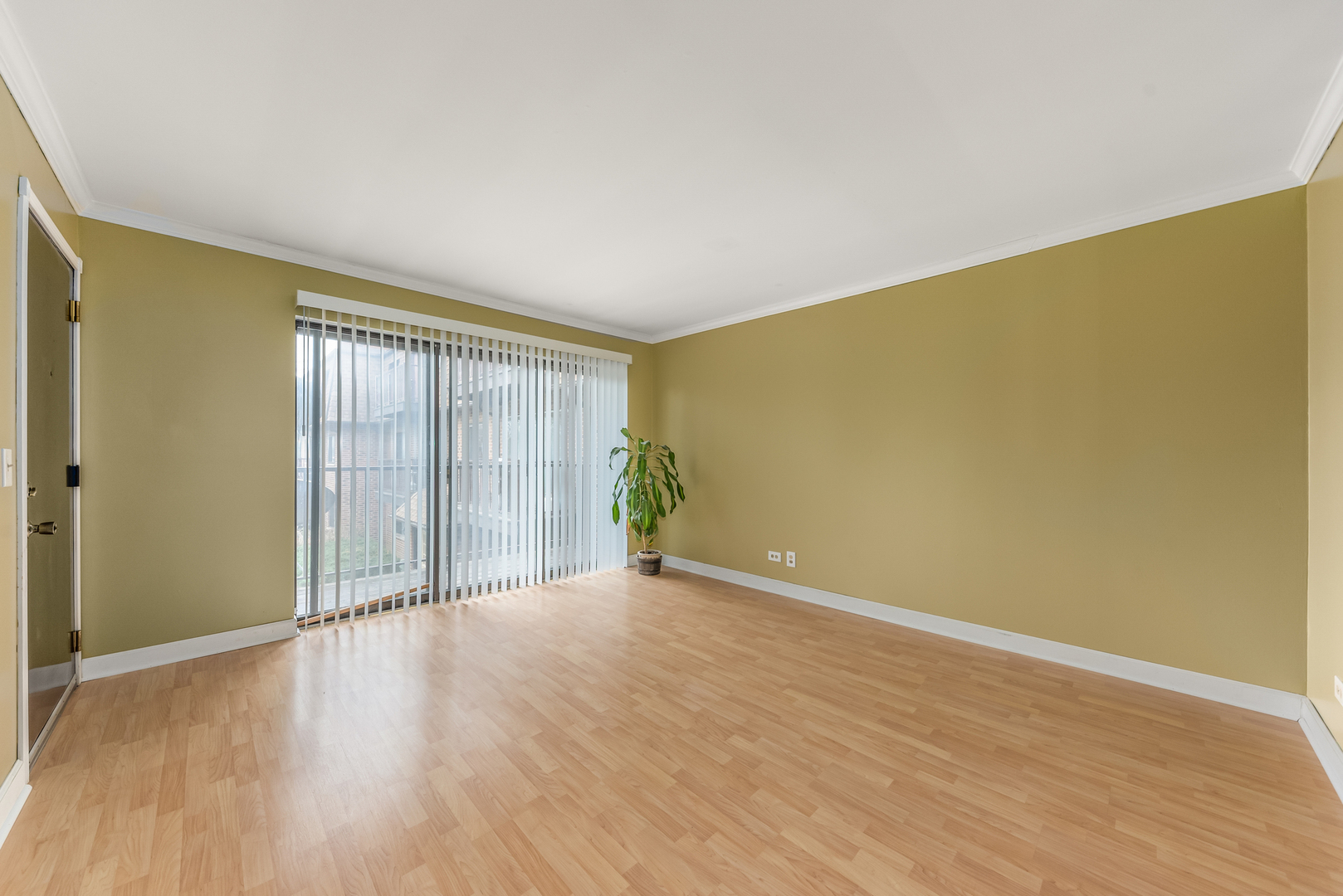 404 East Kensington Road, Unit C Mount Prospect, IL 60056 - Photo 7 of 16 an empty room with wooden floor and windows with curtains