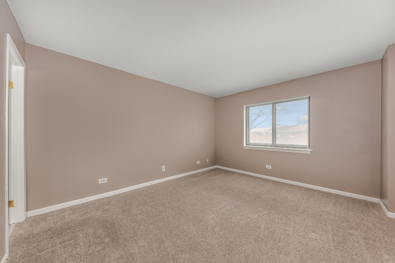 404 East Kensington Road, Unit C Mount Prospect, IL 60056 - Photo 9 of 16 a view of an empty room with a window