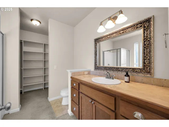a bathroom with a sink vanity and a mirror