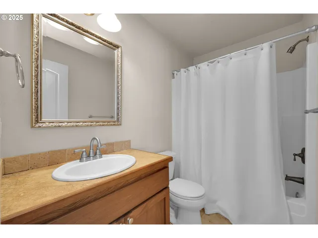 a bathroom with a sink toilet a mirror and vanity