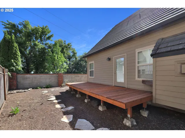 a backyard of a house with barbeque oven fire pit table and chairs