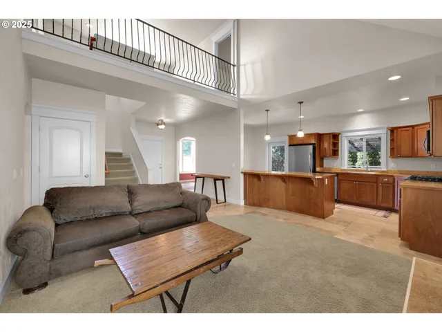 a living room with furniture and kitchen view