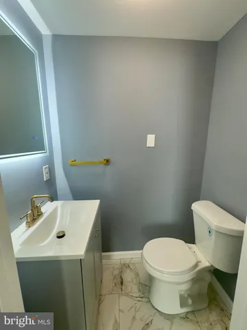 a white toilet sitting next to a bathroom sink