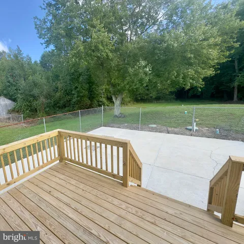 a view of a wooden deck with a yard
