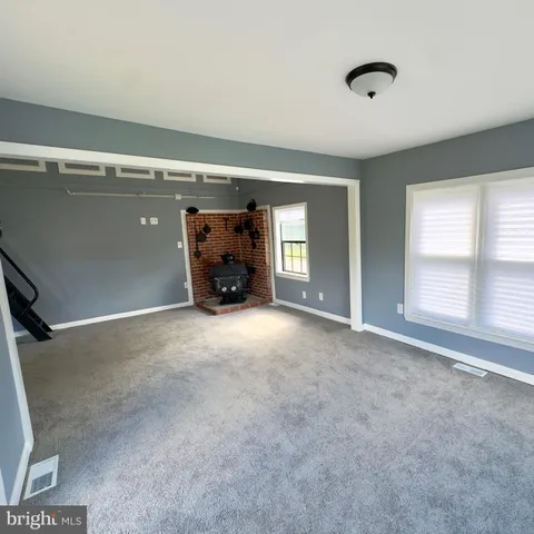 a view of empty room with a fireplace