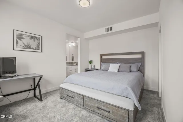 a bedroom with a bed and a chair