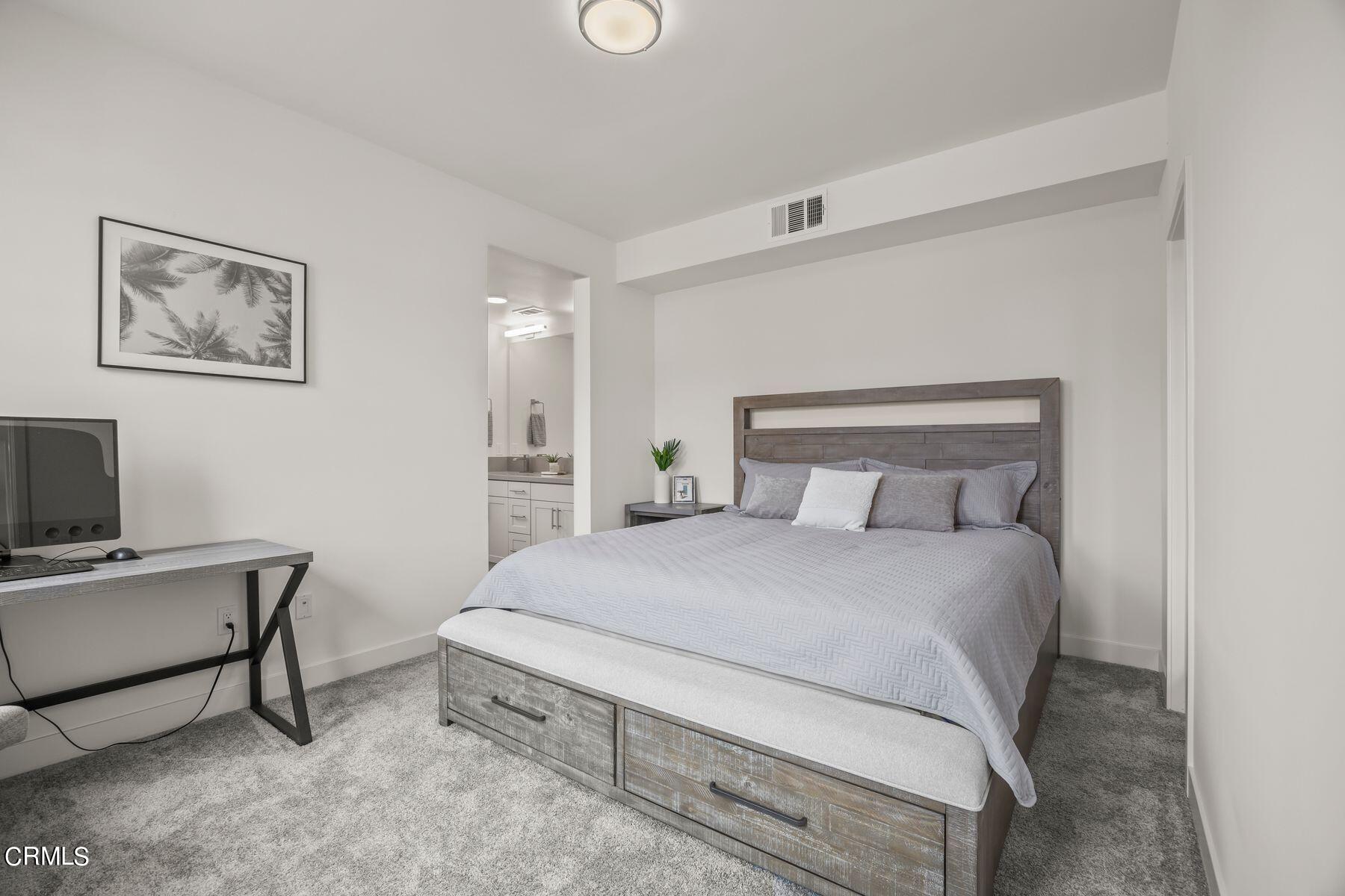 1290 East Thompson Boulevard, Unit 102 Ventura, CA 93001 - Photo 12 of 26 a bedroom with a bed and a chair