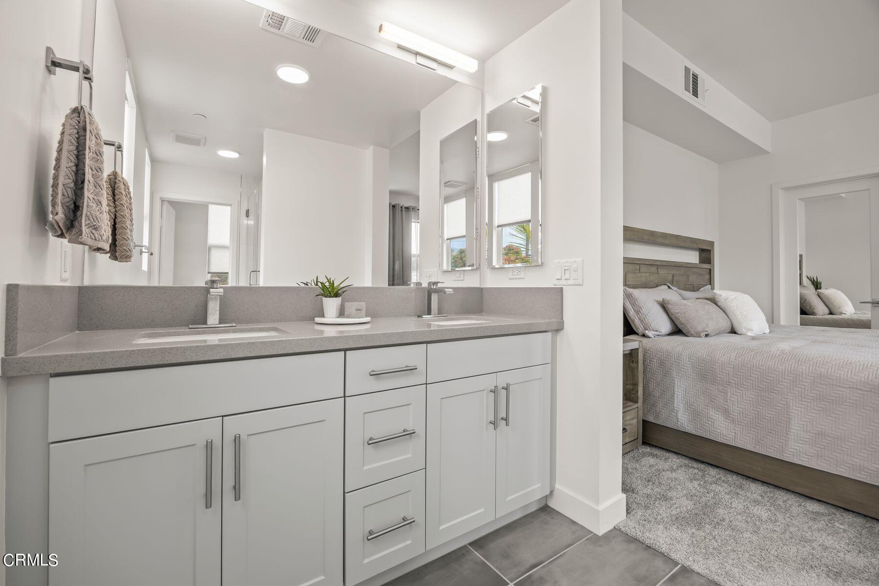 1290 East Thompson Boulevard, Unit 102 Ventura, CA 93001 - Photo 13 of 26 a en suite bathroom with double sink and a large mirror