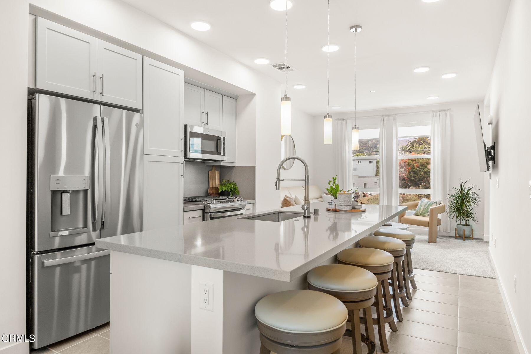 1290 East Thompson Boulevard, Unit 102 Ventura, CA 93001 - Photo 5 of 26 a kitchen with sink refrigerator and microwave