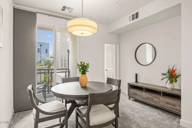 a dining room with furniture and a mirror
