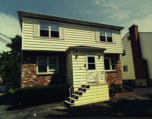 44 Limerick Street Stamford, CT 06902 - Photo 1 of 1 a view of the house with wooden deck and a fireplace
