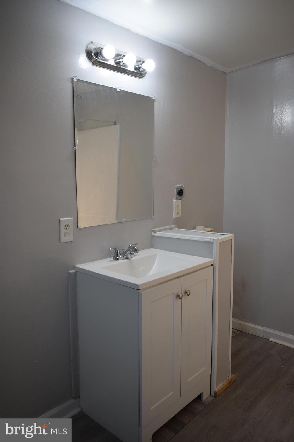 346 South Payson Street Baltimore, MD 21223 - Photo 11 of 29 a bathroom with a sink and a mirror