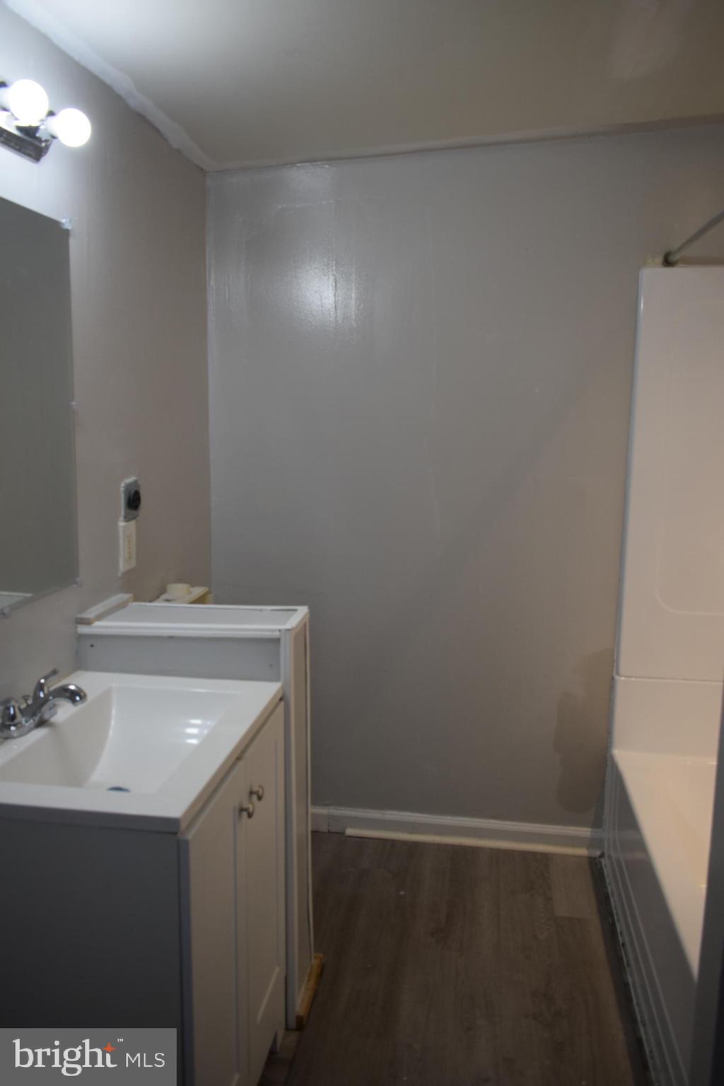 346 South Payson Street Baltimore, MD 21223 - Photo 13 of 29 a bathroom with a sink and a mirror