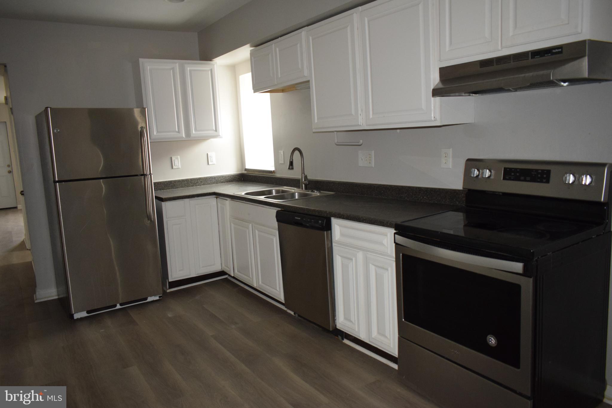 346 South Payson Street Baltimore, MD 21223 - Photo 19 of 29 a kitchen with a sink stove and refrigerator