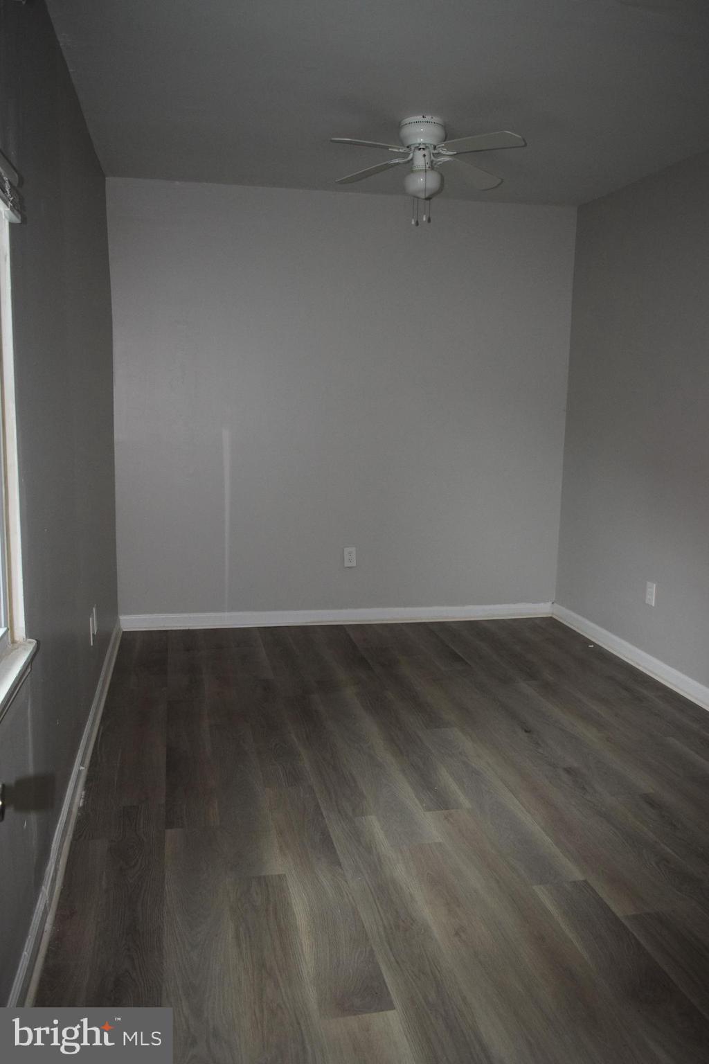 346 South Payson Street Baltimore, MD 21223 - Photo 22 of 29 a view of a room with wooden floor and a ceiling fan