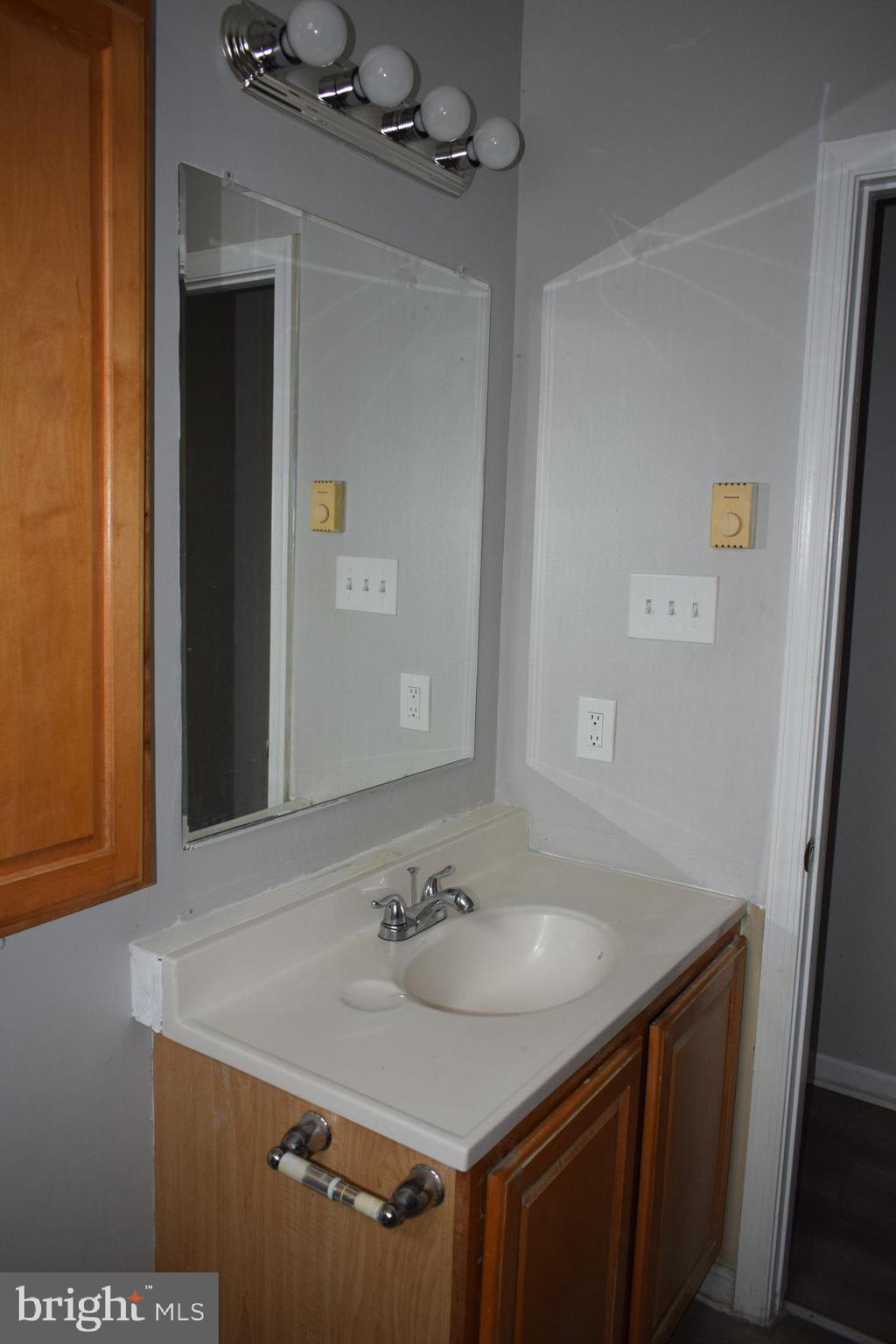 346 South Payson Street Baltimore, MD 21223 - Photo 26 of 29 a bathroom with a sink vanity and a mirror