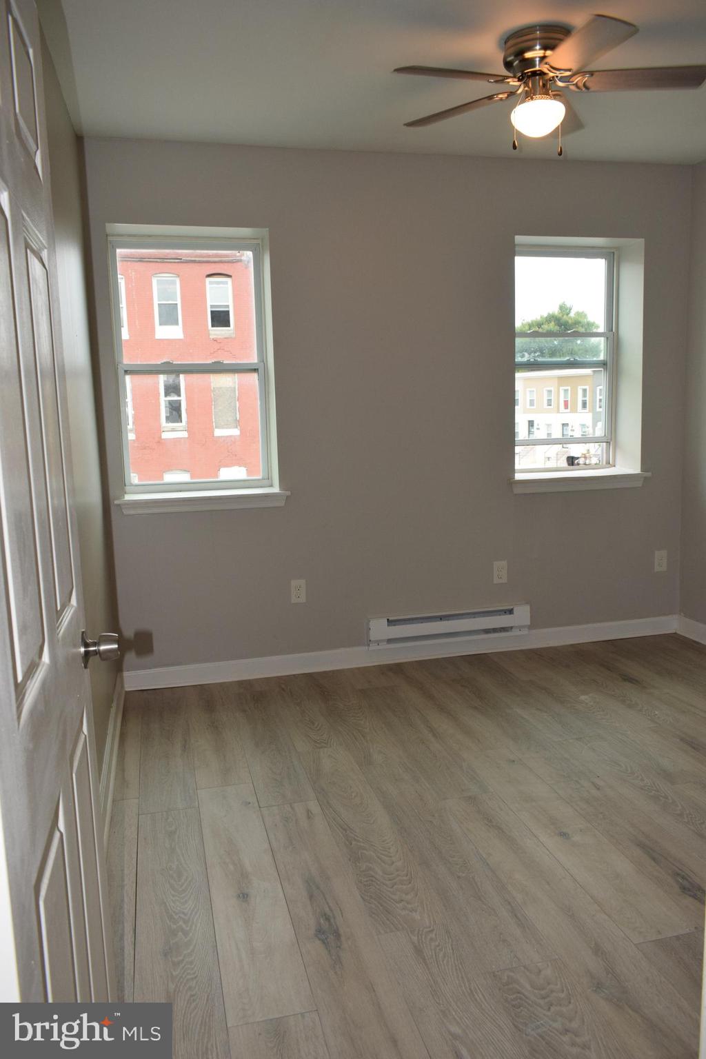 346 South Payson Street Baltimore, MD 21223 - Photo 6 of 29 wooden floor in an empty room with a window