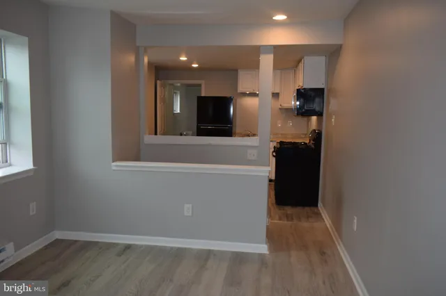 a view of kitchen with wooden floor and electronic appliances